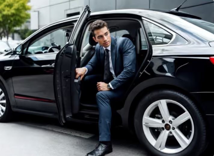 Traveler stepping out of a black chauffeured sedan