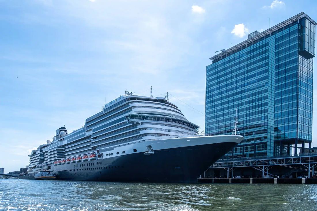 Cruise ship docked at the port next to a hotel