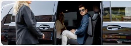 Group stepping out of a chauffeured van